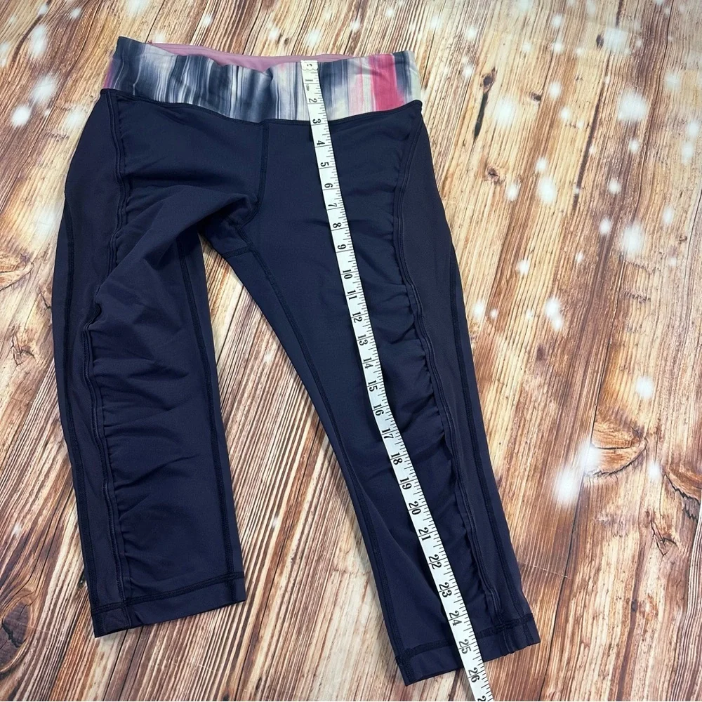 Lululemon Dark Navy ,colorful waist ban and slightly cropped leggings Size 8.